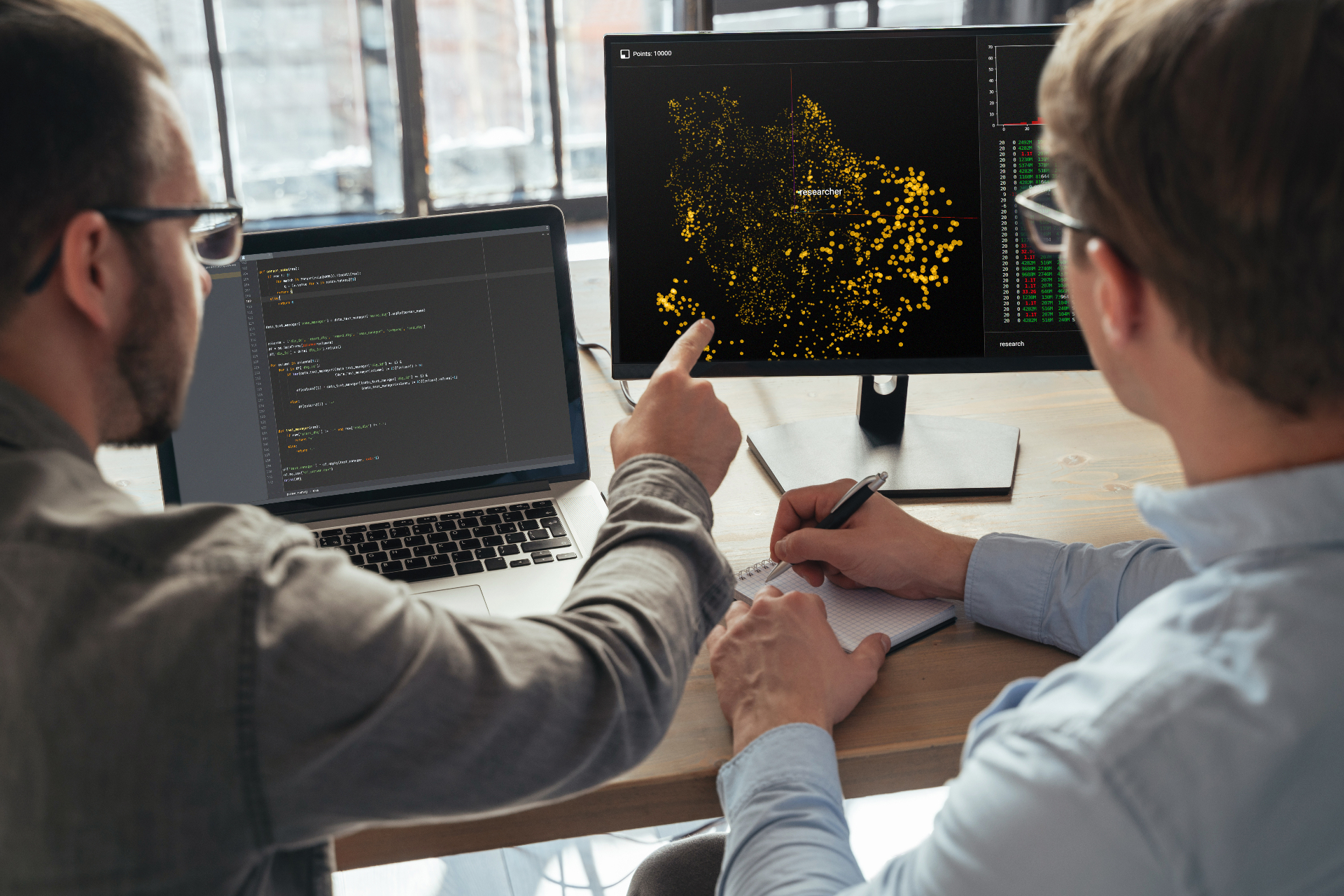 Two analysts reviewing AI data output together — Adobe Stock.
